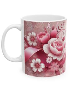 a white coffee mug with pink ribbon and flowers on it