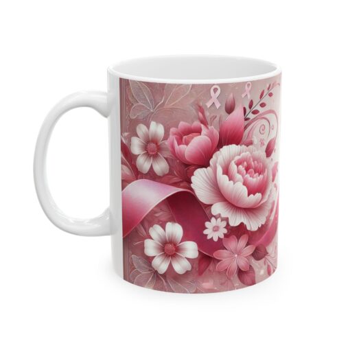 a white coffee mug with pink ribbon and flowers on it