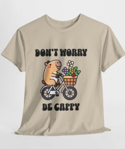 a white t-shirt with a cartoon character riding a bicycle