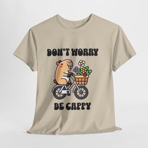 a white t-shirt with a cartoon character riding a bicycle