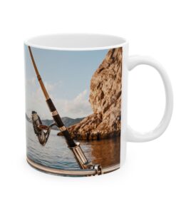 a mug with a fishing pole and a rock in the background