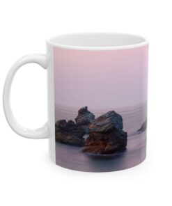 Coffee mug with rocks on the beach on it