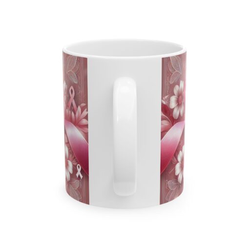 white coffee mug with pink ribbon and white handle