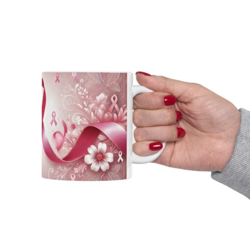 a hand holding a coffee mug