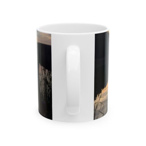 a white coffee mug with a black and white photo of a tree