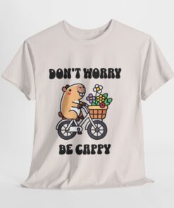 a white t-shirt with a cartoon character riding a bicycle