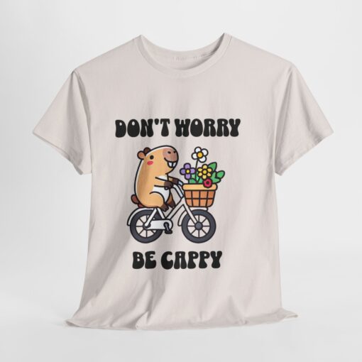 a white t-shirt with a cartoon character riding a bicycle