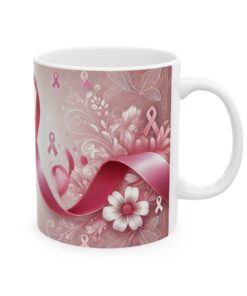 a white coffee mug with pink flowers and ribbons