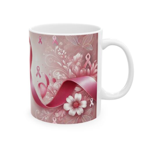 a white coffee mug with pink flowers and ribbons