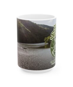 a mug with a picture of a river and trees