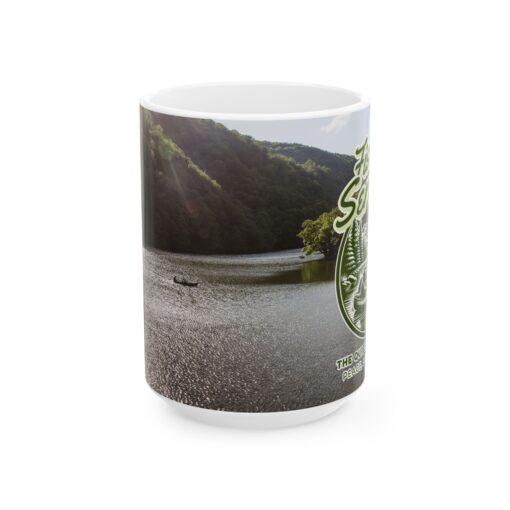 a mug with a picture of a river and trees