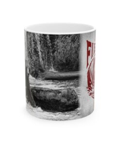 a coffee mug with a picture of a bear by a waterfall