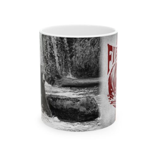 a coffee mug with a picture of a bear by a waterfall