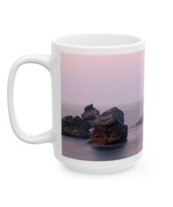 a coffee mug with a picture of rocks in the water