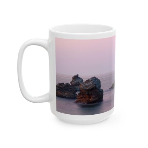 a coffee mug with a picture of rocks in the water