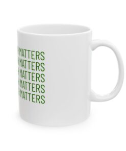 a white mug with green text