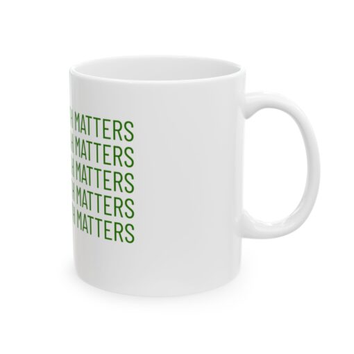 a white mug with green text