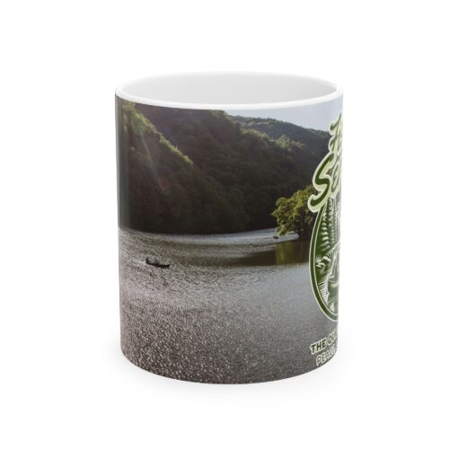 a coffee mug with a image of a man fishing on a lake