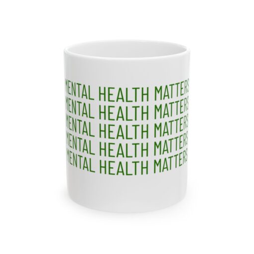 a white mug with green text on it