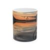 a coffee mug with a fishing pole and a sunset