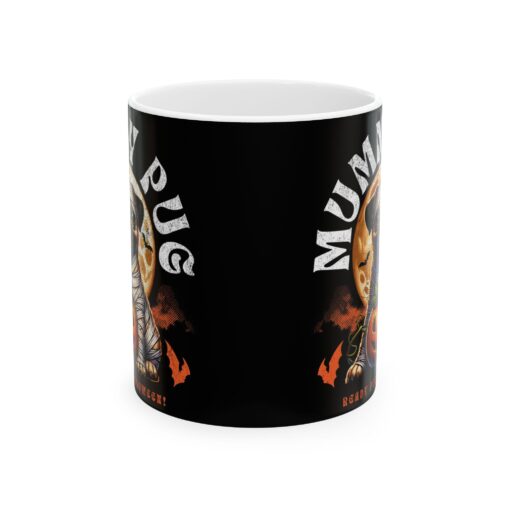 a black coffee mug with a picture of a mummy