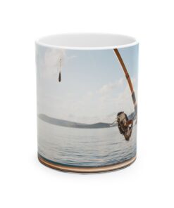 a mug with a picture of a man fishing on the water