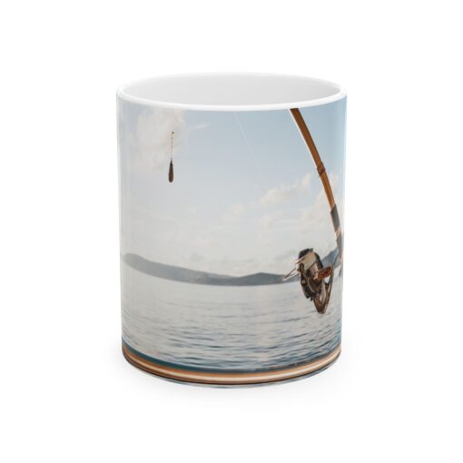 a mug with a picture of a man fishing on the water