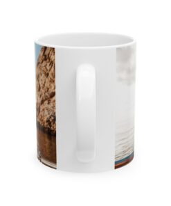 a white coffee mug with a picture of a rock and water