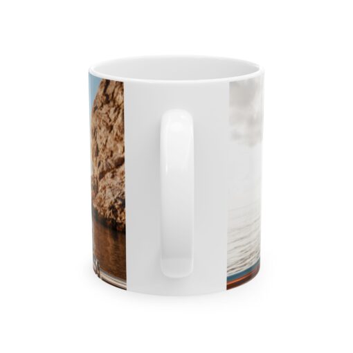 a white coffee mug with a picture of a rock and water