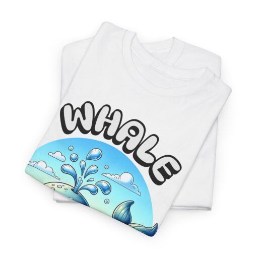 a folded white t-shirt with a whale design