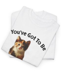 a folded white t-shirt with a cat on it