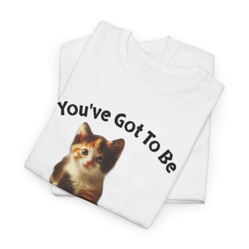 a folded white t-shirt with a cat on it